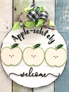 a wooden sign with apples on it that says, apple - solutey welcome