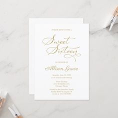 a white and gold wedding card with the word sweet sixteen on it, next to some paintbrushes