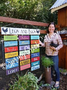 a woman standing next to a sign that says legs and eggs with chickens on it