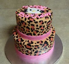 a hello kitty cake with pink icing and leopard print