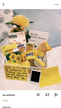 the sunflower is sitting on top of the bed next to some cards and other items