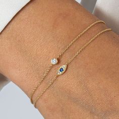 A beautifully crafted bracelet set in 14ct yellow gold, featuring a captivating deep blue sapphire evil eye charm. Designed to be both stylish and symbolic, this delicate piece radiates elegance while also serving as a protective talisman. Build those positive energy feels. Perfect for layering or wearing solo, this bracelet is more than just an accessory—it’s a statement of inner strength and harmony. 100% Recycled 14 Carat Solid Gold - Designed to last forever. Your jewellery will be more dura Colourful Evil Eye Bracelet, White Evil Eye, Blue Sapphire Bracelet, The Evil Eye, Solid Gold Bracelet, September Birthstone Jewelry, Blue Evil Eye, Sapphire Bracelet, Pearl Jewellery Earrings