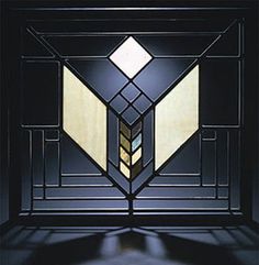 an art deco stained glass window in a dark room