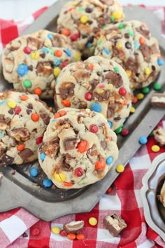 chocolate chip cookies with m & m and candy on the top are ready to be eaten