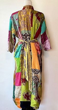 This stand-out kimono is full kaleidoscope of bright colors like a blooming spring garden. Constructed with high quality, ultra luxe sari silk, handmade. Designed as a traditional long kimono with an extra wide front band and self tie belt. Special detailing is noticable throughout the garment, double width hem panel, etc. Feels wonderful against your skin. Worn open, breezy flowing statement. The bright color pallet works well with most skin tones. True statement, one-of-a-kind designer piece. Handmade Long Multicolor Kimono, Traditional Long Patchwork Kimono, Long Multicolor Silk Kimono, Luxury Traditional Multicolor Kimono, Bright Color Pallets, Silk Patchwork Long Sleeve Kimono, Long Kimono, Sari Silk, Silk Kimono