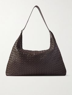 Bottega Veneta's spacious tote bag has a relaxed, slouchy shape that makes it really comfortable to carry. It's woven from supple strips of textured-leather using the house's timeless intrecciato technique and holds plenty of space for a laptop and an extra layer. Adjust the strap to your desired length. Luxury Tote Hobo Bag For Errands, Luxury Textured Leather Hobo Tote Bag, Business Tote Shoulder Bag With Intrecciato Weave, Business Intrecciato Weave Tote Shoulder Bag, Business Intrecciato Tote Shoulder Bag, Luxury Hobo Tote Bag For Business, Luxury Woven Leather Hobo Bag For Travel, Business Woven Leather Tote Bag, Business Tote Bag In Woven Leather