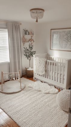 a baby's room with a crib, rocking chair and rug