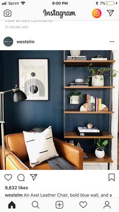 a living room filled with furniture and bookshelves next to a wall mounted art