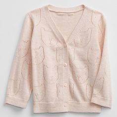 a pink cardigan sweater with an animal pattern on the chest and buttons at the front