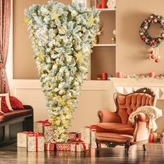 a living room filled with lots of furniture and christmas decorations on top of the floor