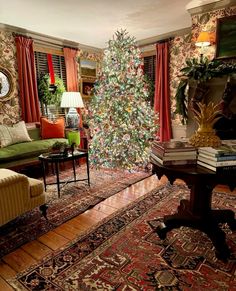 a living room with a christmas tree in the corner