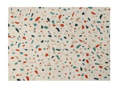 an area rug with multicolored spots on the floor and white ground, in front of a white background