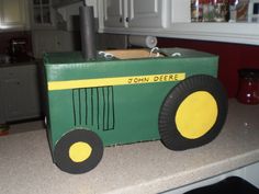 a cardboard box shaped like a tractor sits on a kitchen counter