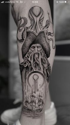 an octopus and ship tattoo on the arm