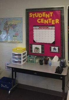 a desk with a calendar on it in front of a map and other school supplies