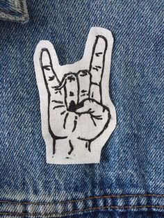 a sticker on the back of a jean jacket with a peace sign painted on it