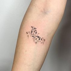 a small dog tattoo on the right arm and leg, with stars coming out of it