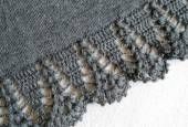 an image of the side of a knitted shawl