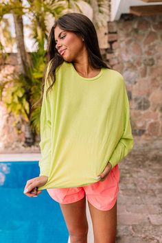 - Perfect for a pop of color, this beautiful top is a perfect casual closet staple! - Soft, lightweight lime punch colored material - Round neckline - Long dolman sleeves - Relaxed silhouette that ends in a uneven rounded hemline Casual Lime Green Cotton Top, Neon Cotton Crew Neck T-shirt, Lime Punch, Dolman Sleeve, Round Neckline, Color Pop, Luxury Fashion, Fashion Trends, Color