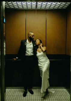 a man standing next to a woman in a bathroom