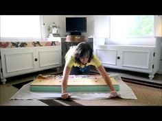 a young boy is playing with an inflatable mattress on top of the floor