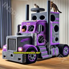 a cat sitting on the top of a purple truck bed in a room with curtains