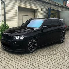 a black car parked in front of a building