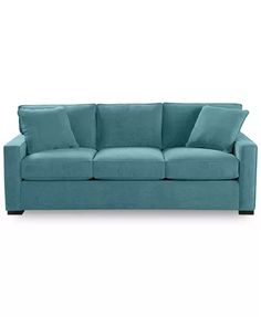 a blue couch sitting on top of a white floor