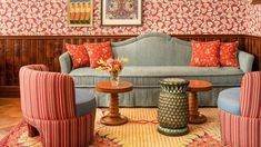 a living room filled with furniture and colorful wallpaper