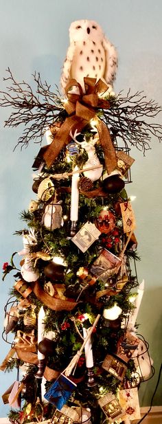 a decorated christmas tree with teddy bears and other items on it's top shelf