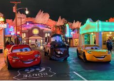 cars are lined up on the street at night