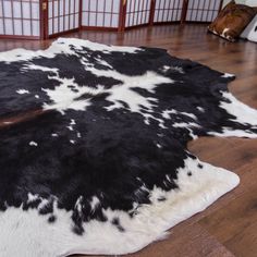 a black and white cowhide rug on the floor