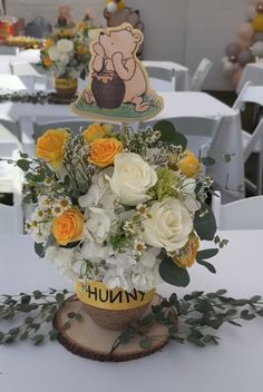 there is a vase with flowers in it on the table at an event or gathering