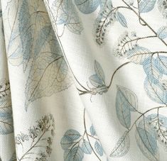 a white and blue floral print fabric with small leaves on it's back side