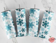 four teal snowflakes are hanging on clothes pins in front of a marble background