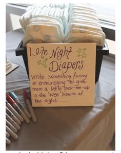 a sign that says late night diapers on top of a table with other items