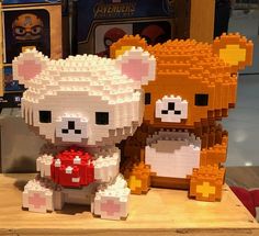 two lego animals sitting next to each other on a table