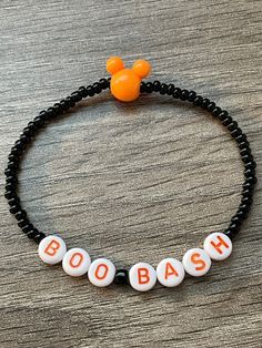 It's really not so scary!  Trick or Treating at a Boo Bash party?  Well this is the perfect accessory for you!  Handmade beaded elastic bracelet with black glass seed beads, round letter discs and an orange mouse ears bead to complete this piece!  Wear it to the parks or all spooky season long!  Bracelets are available in a variety of lengths.  Pick your custom length from the drop down menu below.  All our bracelets are made with quality in mind.  With that being said, all bracelets should be t Disney Beads Bracelet, Personalized Fun Black Beaded Bracelets, Black Beaded Bracelets For Party In Novelty Style, Novelty Black Beaded Bracelets For Halloween, Black Novelty Stretch Bracelet, Novelty Beaded Bracelets For Halloween, Black Beaded Bracelet For Halloween, Black Beaded Stretch Bracelet For Halloween, Adjustable Beaded Stretch Bracelet For Halloween