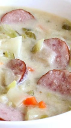 a close up of a bowl of soup with meat and vegetables