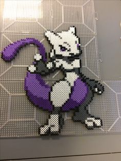 an image of a cat made out of perler beads on a piece of plastic