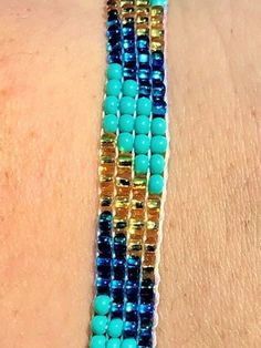 "Perfect for a pop of color! This turquoise \"skinny\" bracelet will charm your way through the day. Made using brilliant glass seed beads and premium nylon, these bohemian styled bracelets are dressed to impress and are a must-have every day accessory! Makes for a great birthday gift, Christmas gift, holiday gift, stocking stuffer, friendship bracelet and especially a \"just because\" gift for mom! Delicately handmade in Guatemala *Please note that all of our items are handcrafted and unique to Blue Spacer Beads Bracelets For Festivals, Blue Festival Bracelets With Spacer Beads, Bohemian Blue Bracelets With Spacer Beads, Adjustable Turquoise Wrap Bracelet For Festival, Blue Bohemian Bracelets With Spacer Beads, Bohemian Braided Bracelets With Beads For Summer, Bohemian Round Beads Jewelry For Friendship, Bohemian Turquoise Beaded Braided Bracelets, Bohemian Braided Beaded Bracelets For Summer