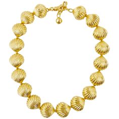 This Gianni Versace gold tone shell necklace is from the Spring Summer 1992 Tresor de la Mer collection which was inspired by the abundant treasures of the sea, reminiscent of Gianni's hometown in Calabria. The necklace is made up of 18 gold plated shells that all link together forming a short collar necklace. The back two shells have the famous medusa head detailing with a claw clasp to secure the necklace. This stunningly simple item will had a touch of the Mediterranean style to any outfit. W Simplistic Jewelry, Versace Necklace, Vintage Gold Necklace, Gold Collar Necklace, Vintage Choker Necklace, Claw Necklace, Versace Gold, Vintage Choker, Stone Choker