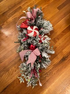 a christmas wreath with candy canes and greenery