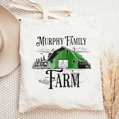 a tote bag with the words murphy family farm on it next to a straw hat