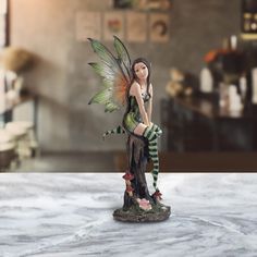 a fairy figurine sitting on top of a table