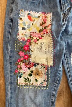 an old pair of jeans with flowers on them