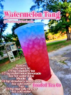 a hand holding up a red, white and blue drink