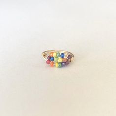 Looking for a unique fidgeting tool for back to school? This ring (along with almost all of my other styles and colors) are great for small, fidgeting hands. ***Please note, although this ring is tarnish resistant, I do not recommend wearing it while swimming,bathing etc.***Made with multicolored beads and your choice of either gold, silver, or copper , tarnish resistant band . I can also do any color combination you want, including school colors . Please message me for questions about sizing , Fidjet Ring, Daughter Fidget Ring, Mechanical Fidget Ring, Adjustable Fidgit Rings, Silver Fidget Rings Spin, Worried Kids, Pumpkin Soap, Worry Ring, Sea Glass Ring