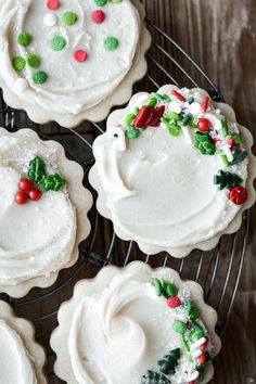 decorated cookies sitting on top of a cooling rack