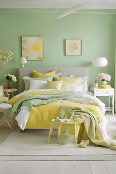 a bedroom with green walls and white carpeted flooring, yellow comforter on the bed